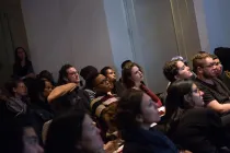 A group of people sitting down.
